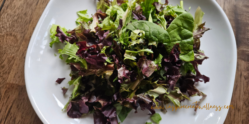 Leafy Greens, spinach and spring lettuce for salad on a plate