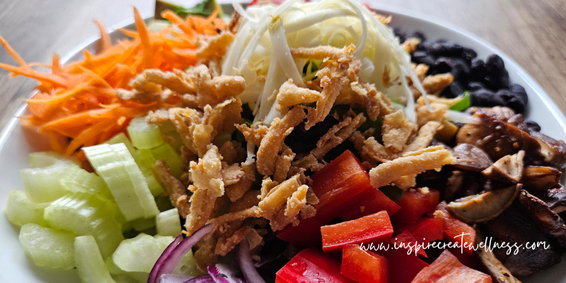 bbq black bean salad with shredded cheese and organic fried onion straws