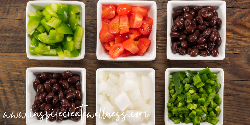 Organic veggies chopped in small white bowls