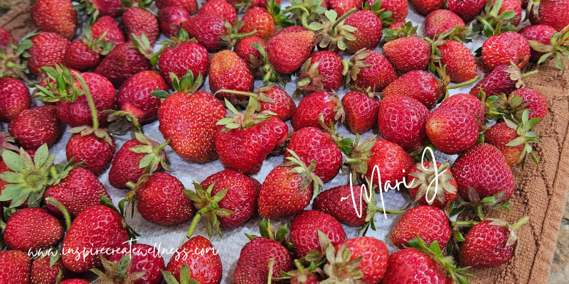 Fresh picked strawberries with stems and leaves