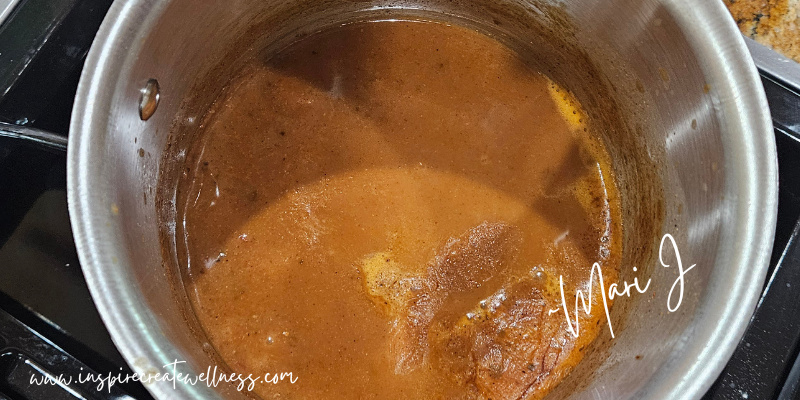 Homemade enchilada sauce in a small sauce pan after boiling