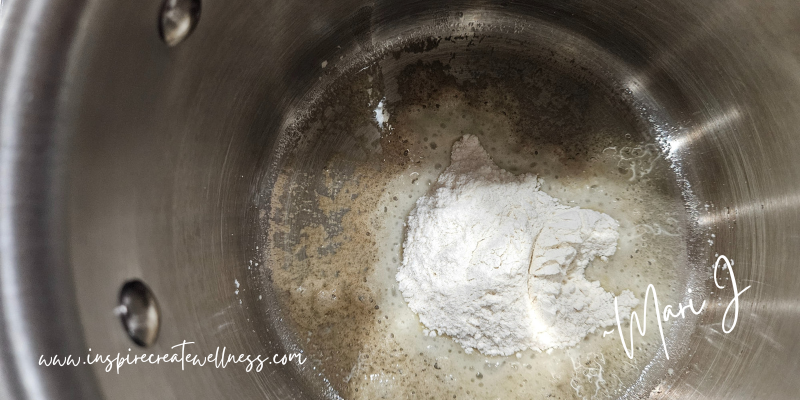 Flour and olive oil added to a small stainless steel saucepan