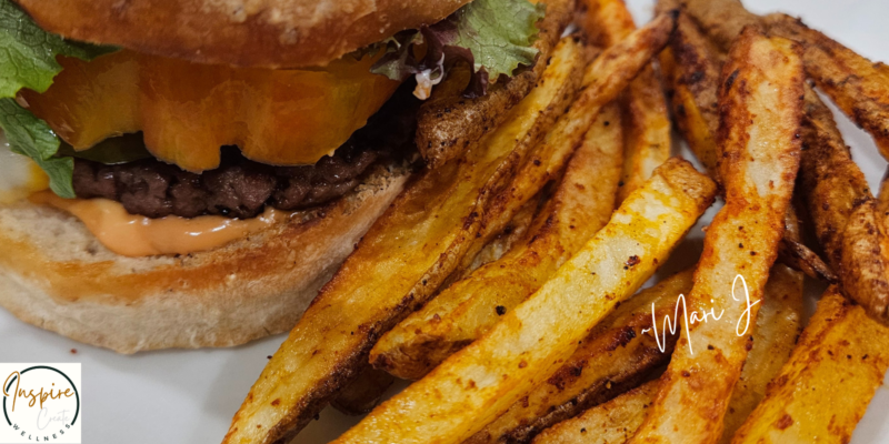 Organic French Fries on a white plate with a plant based burger