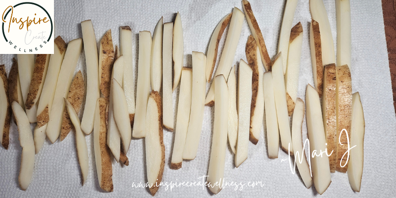 Organic Russet Potato Fries laid out on a kitchen towel to dry.