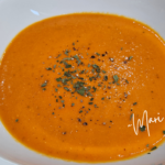 Creamy roasted tomato soup in a white bowl