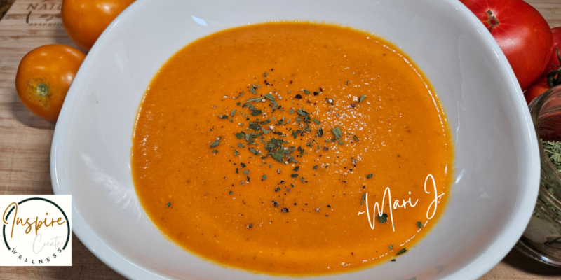 Creamy roasted tomato soup in a white bowl