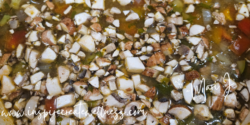 Chopped Mushrooms added to hearty homemade minestrone soup in a dutch oven