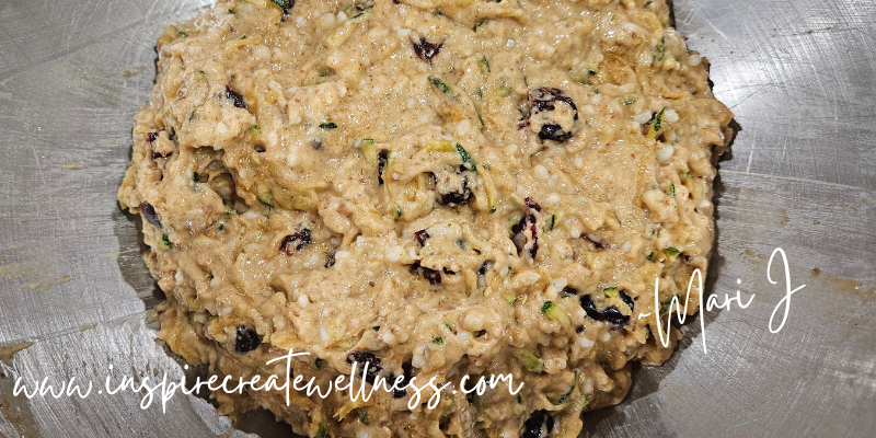 Zucchini muffin batter with cranberries and walnuts