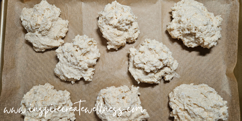 Delicious Homemade Biscuits on a cookie sheet lined with unbleached parchment paper