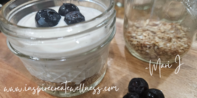 Healthy Cheesecake in a mini glass jar with blueberries on top