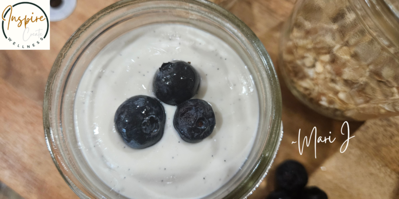 Healthy Cheesecake in a jar with 3 blueberries on top