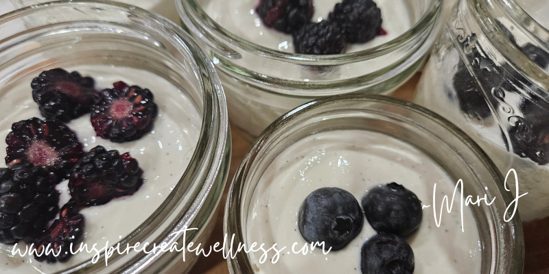 Blueberries and black berries on top of healthy cheesecake jars