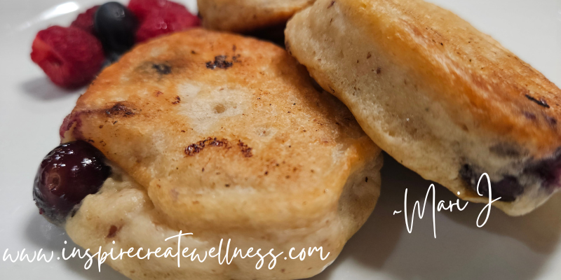 Blueberry Kefir Pancakes on a white plate with berries