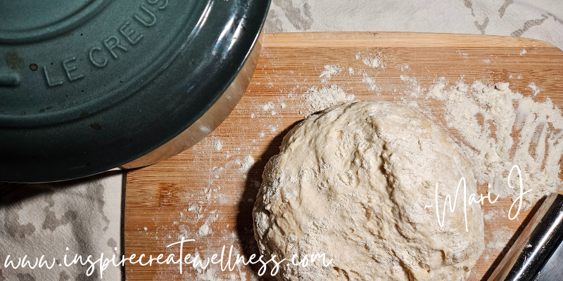 Dutch Oven and Easy Honey Oat Bread Dough on a floured cutting board